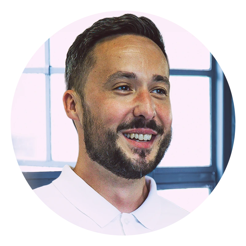 Jason Windle smiling with short hair and a beard, wearing a white shirt.