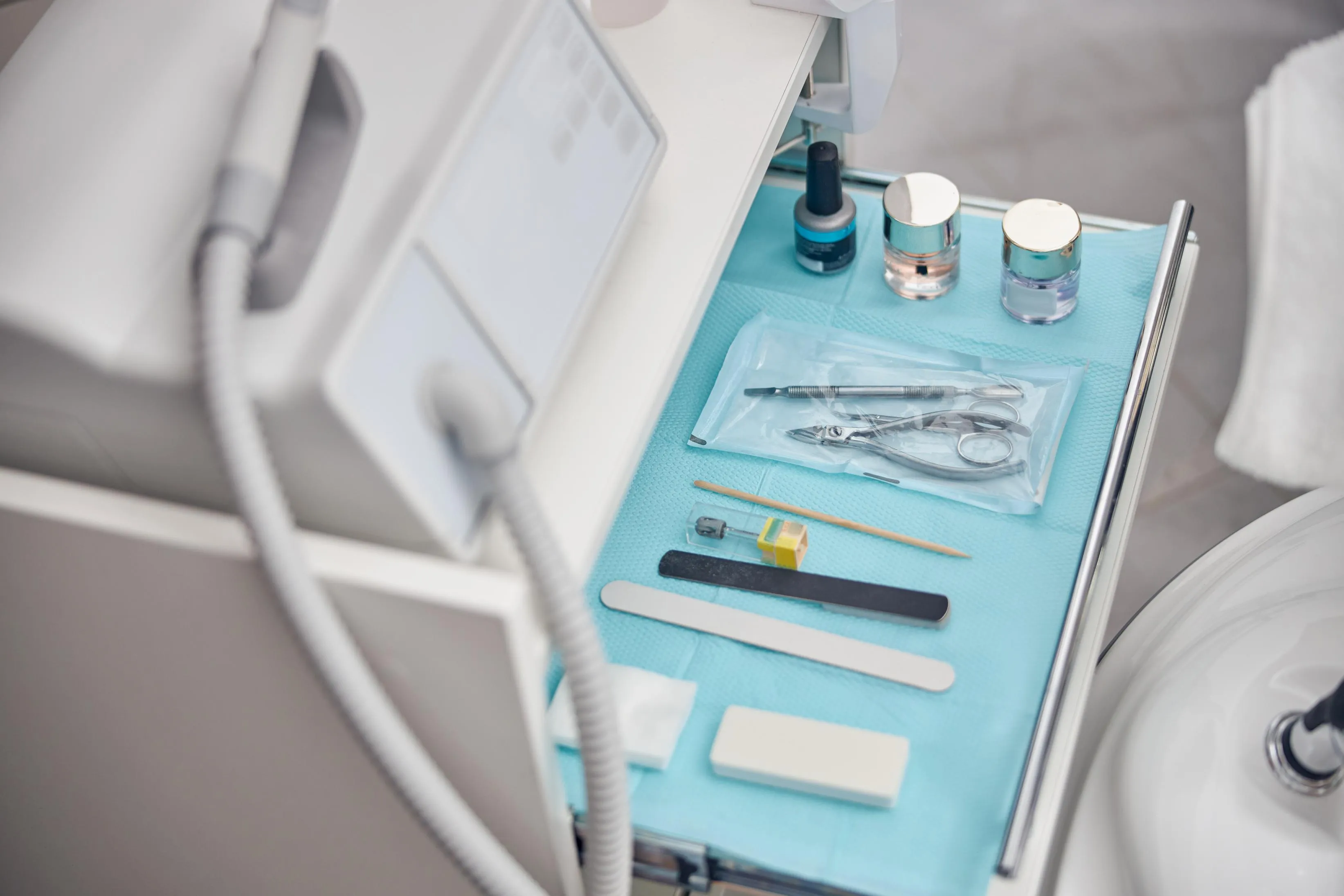 Sterilized dental instruments neatly arranged on a blue tray inside a modern operatory showing a clean, professional setup for patient treatment and hygiene safety