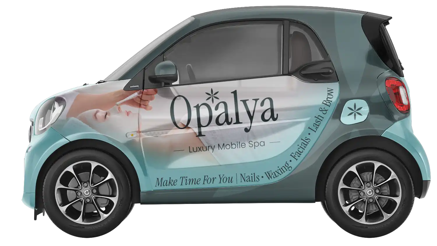 Small teal and gray smart car with Opalya Luxury Mobile Spa advertisement featuring a woman receiving a facial and services listed below.