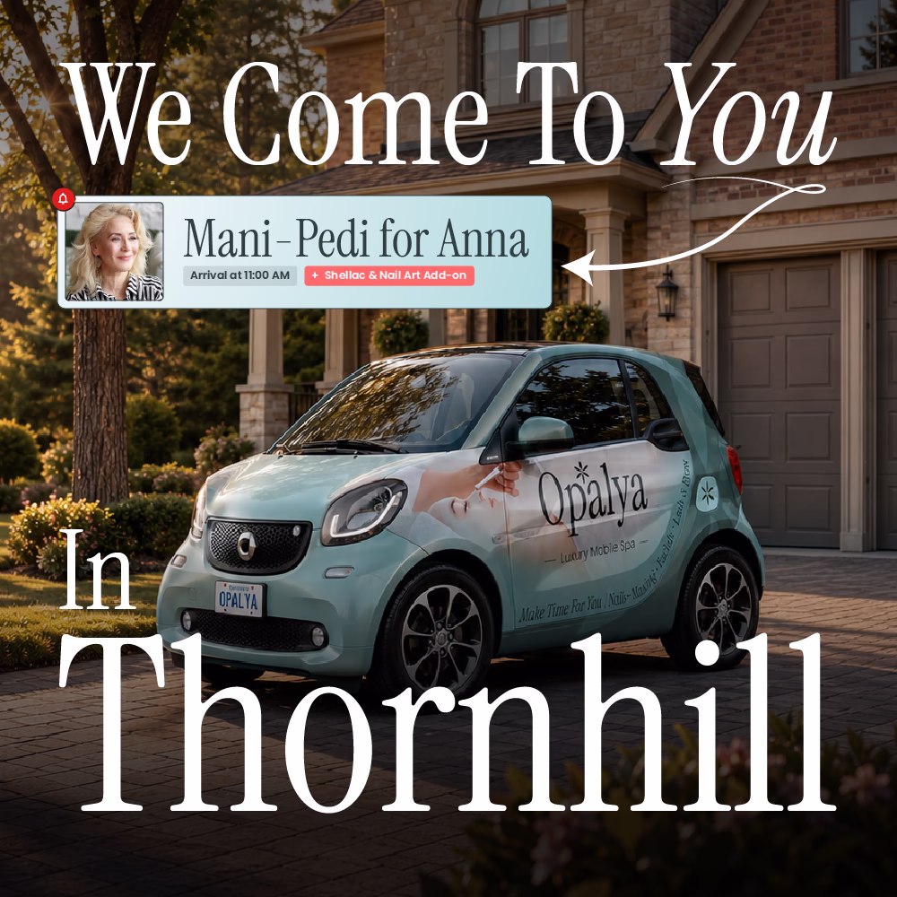 Small teal car with Opalya Luxury Mobile Spa logo parked outside a house at sunset.