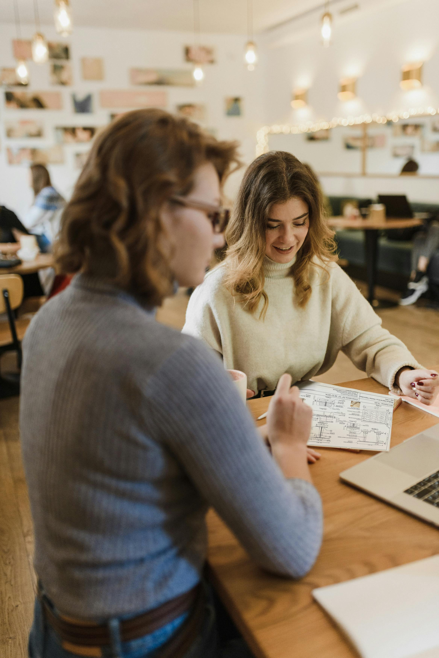 Two women reviewing Margeaux shop drawings