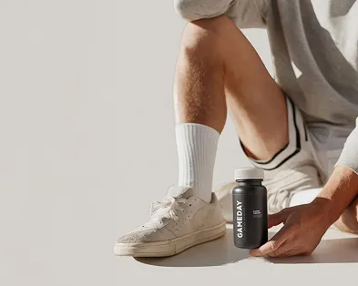 Fit man holding a Clomid pill bottle, highlighting treatment options for boosting testosterone and supporting men’s wellness.