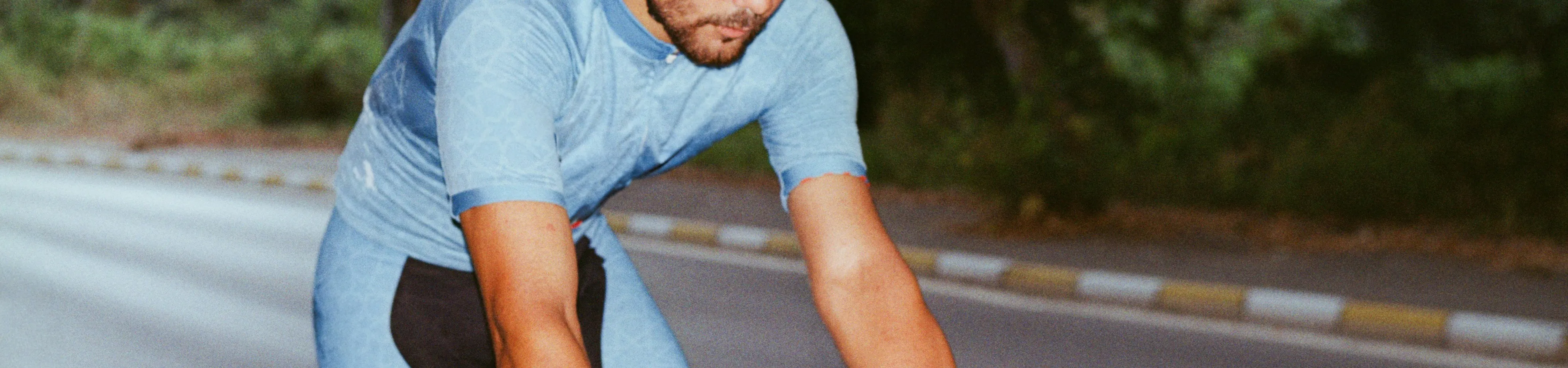 Man riding a bike wearing a blue outfit
