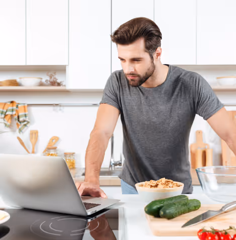 Man cooking healthy meal as part of weight loss nutrition plan