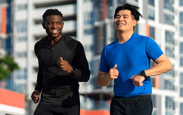 Two men jogging outside, representing increased energy and wellness after IV vitamin therapy.