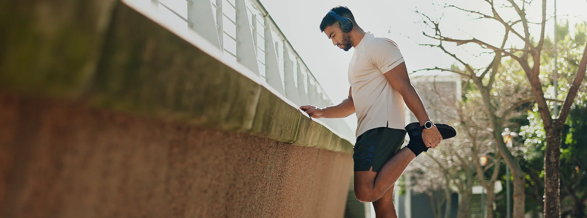 Man stretching leg outdoors before exercise after vitamin injection therapy