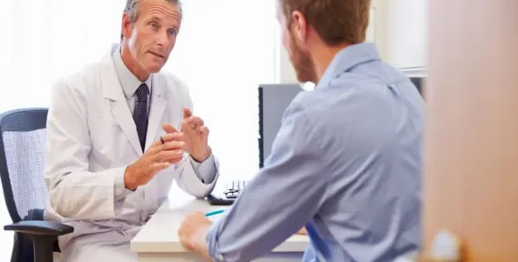 Male patient consulting with a doctor about Trimix injection therapy for erectile dysfunction treatment.