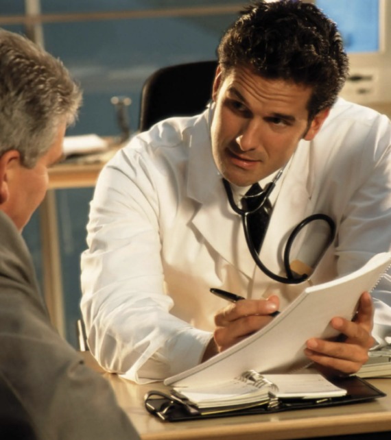 Doctor consulting with male patient about Trimix injection therapy for erectile dysfunction treatment.