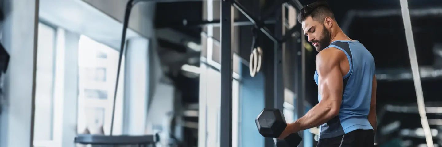 Man doing a bicep curl exercise showing strength gains from Clomid