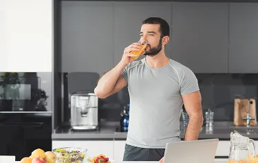 Man enjoying a healthy drink, supporting his weight loss journey with balanced nutrition and medical weight loss solutions