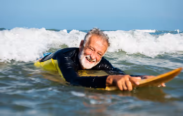 Man running near water with earphones in, reflecting boosted stamina and metabolism support from B vitamin therapy.