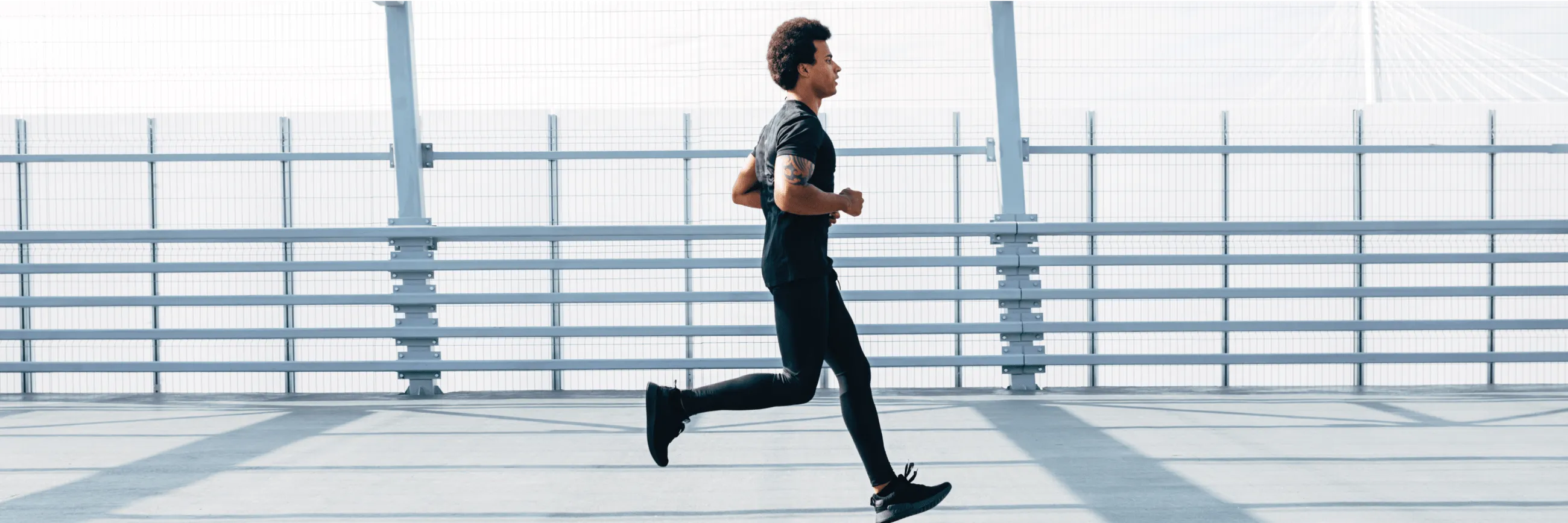 Man jogging outdoors on a bright day, promoting active lifestyle benefits of vitamin C injections.