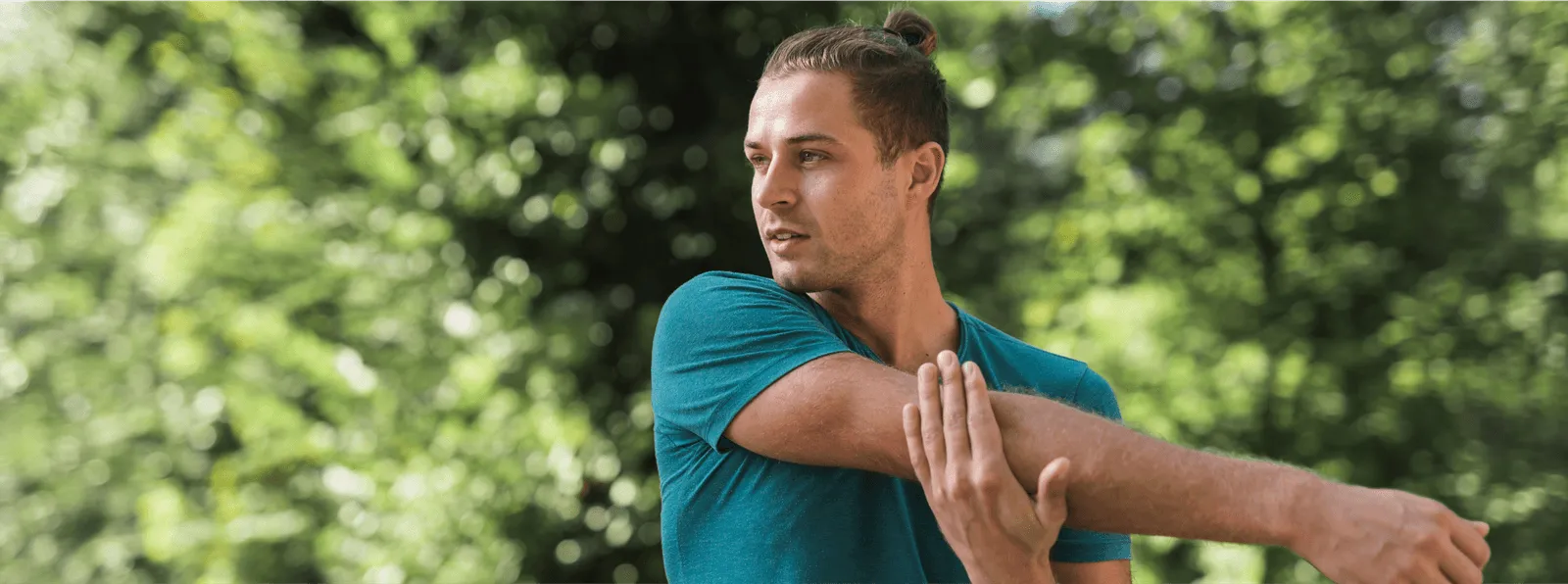 Young man stretching outdoors in athletic wear, highlighting the muscle recovery and immune-boosting benefits of Vitamin C injections for men.