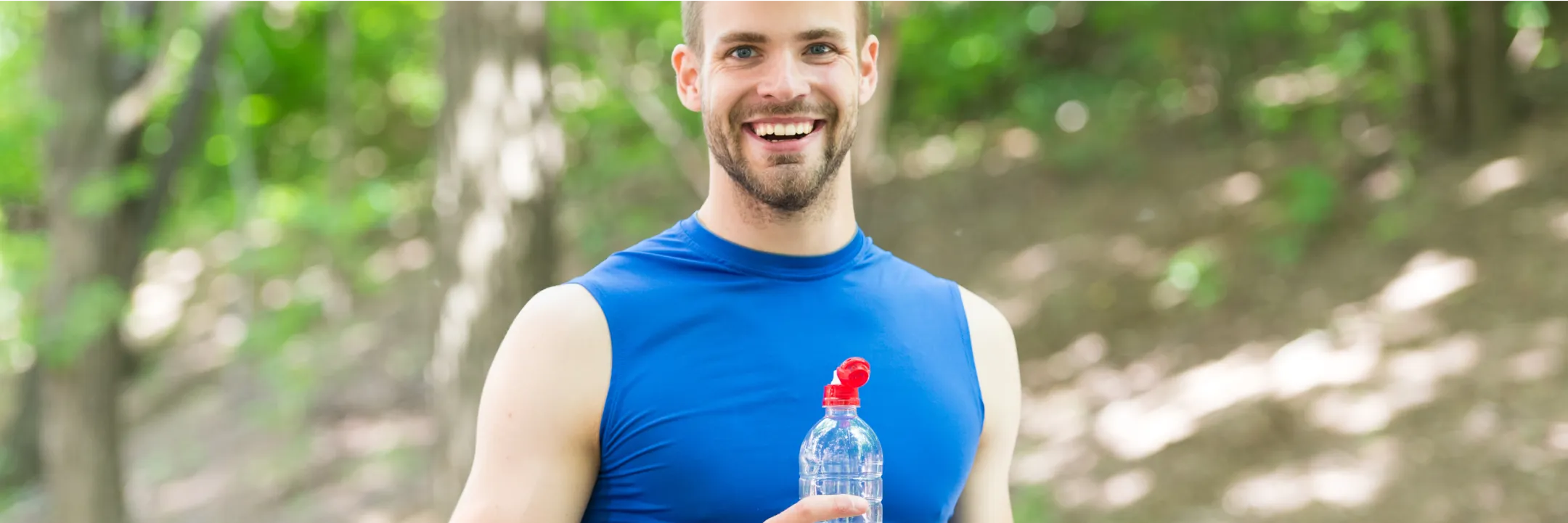 Man running near water with earphones in, reflecting boosted stamina and metabolism support from B vitamin therapy.
