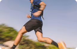 Man running outdoors, symbolizing recovery, restored movement, and pain relief from sports injury treatments.