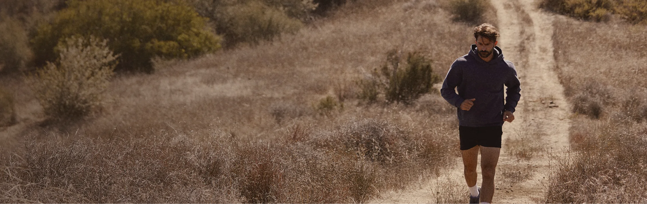 Athletic man running through a field, representing energy, mobility, and long-term wellness at Gameday Men’s Health.