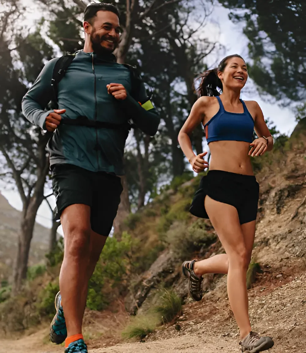 Two people running outdoors as part of a medical weight loss program