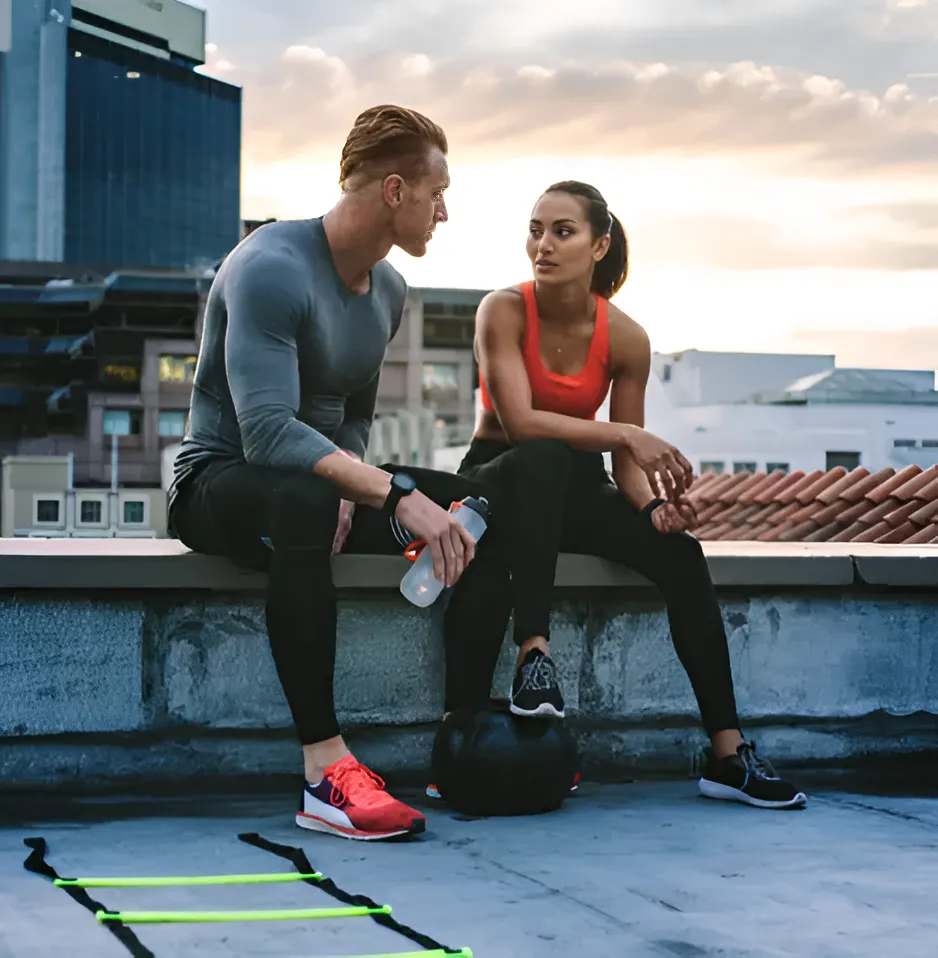 Two people resting and talking after a workout during a medical weight loss program