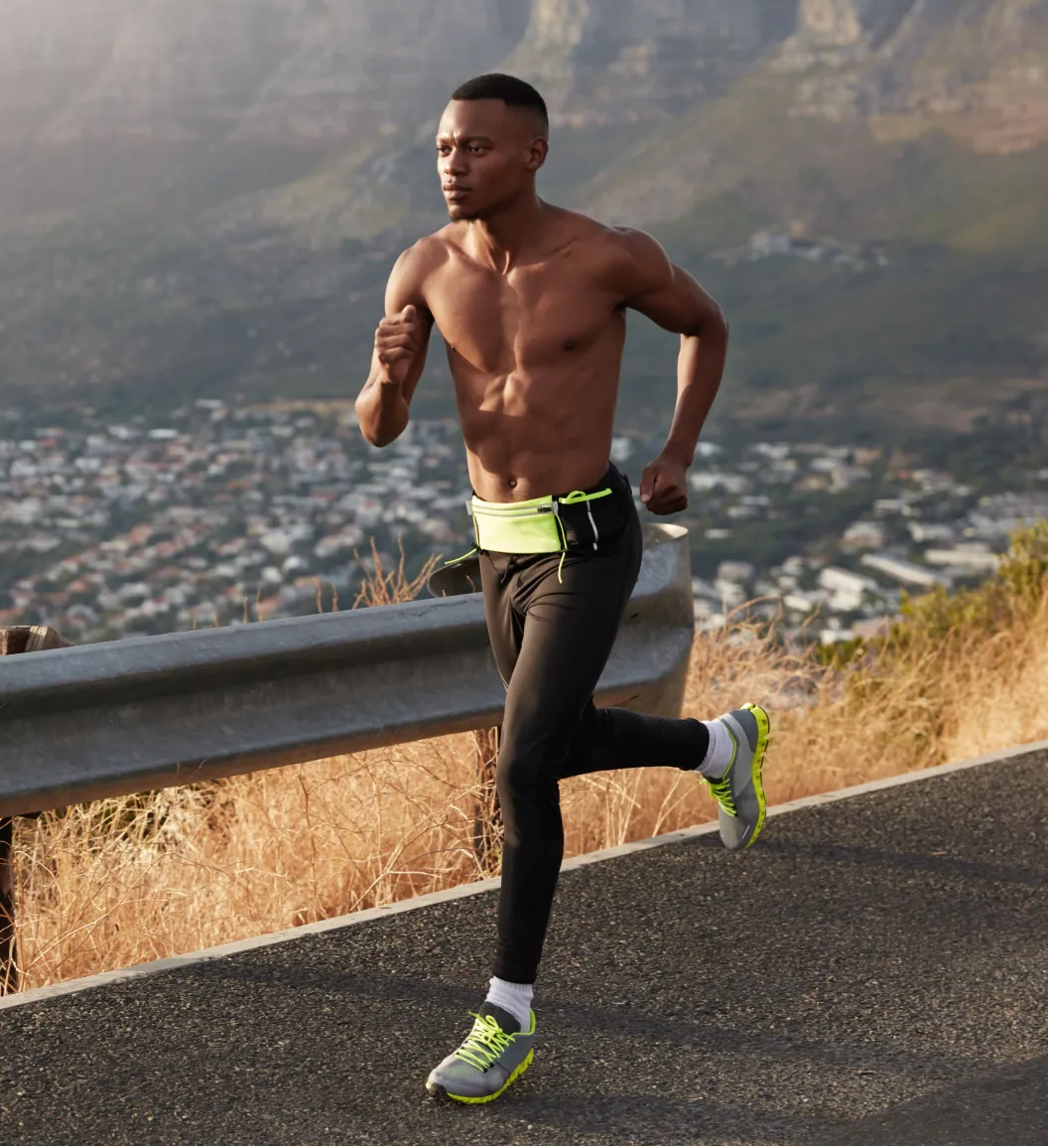 A fit man running outdoors symbolizes an energy boost from Clomid therapy