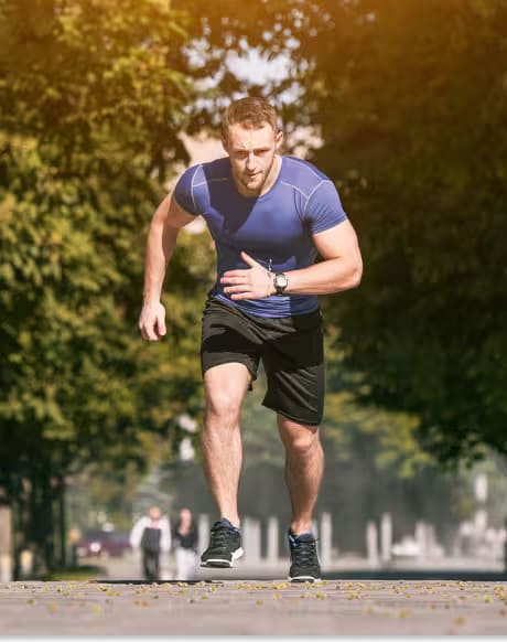 A man runs on a city street, showcasing an active lifestyle featured in Men's Health.  