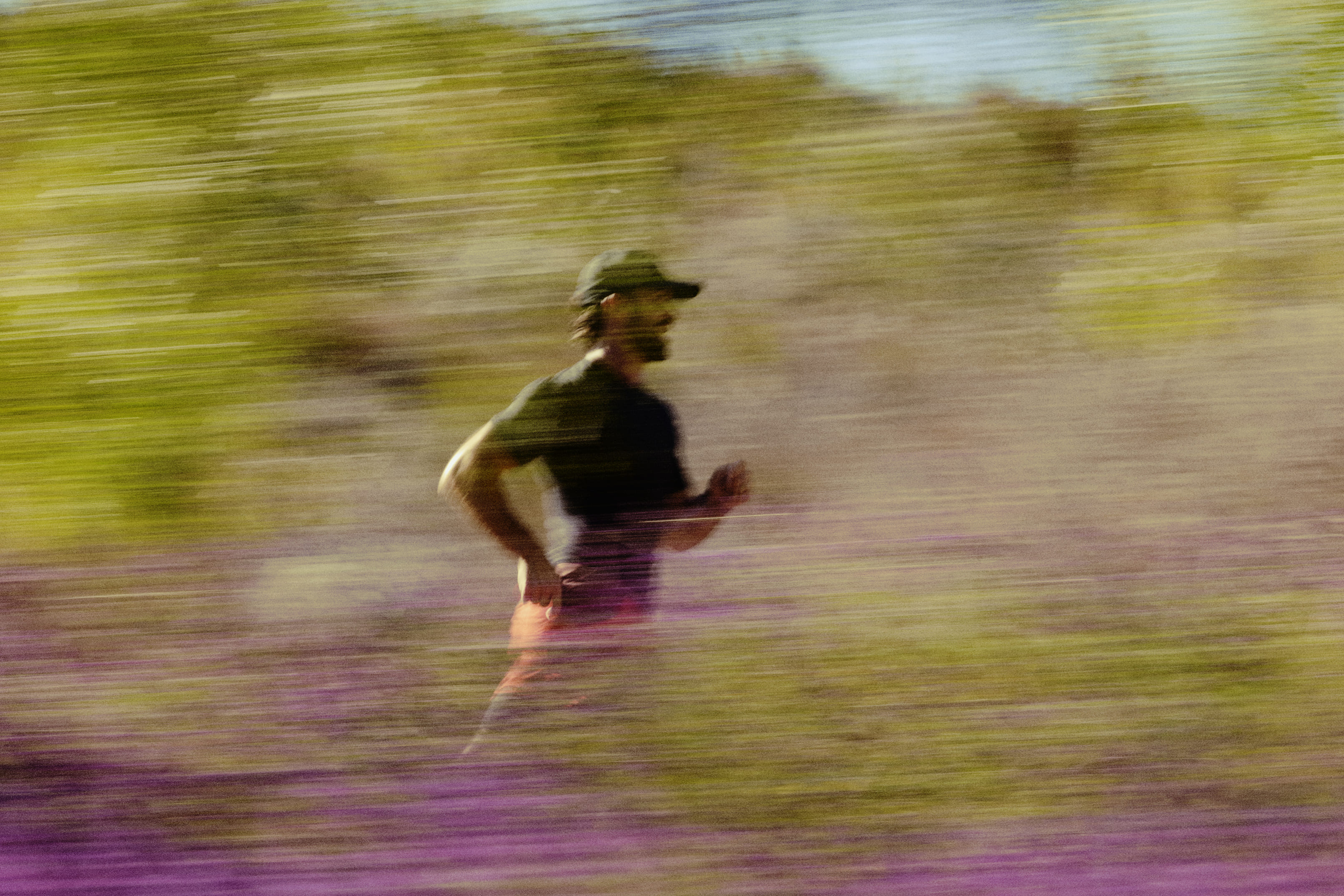 Middle-aged man jogging through a park, representing improved vitality and energy from oral testosterone therapy.