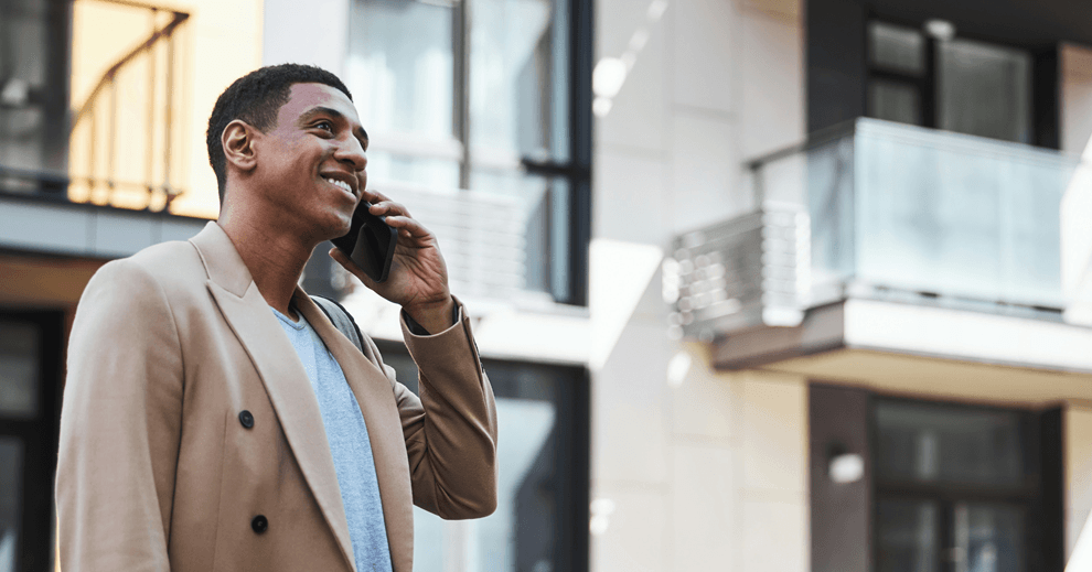 Business man talking on the phone to book appointment.