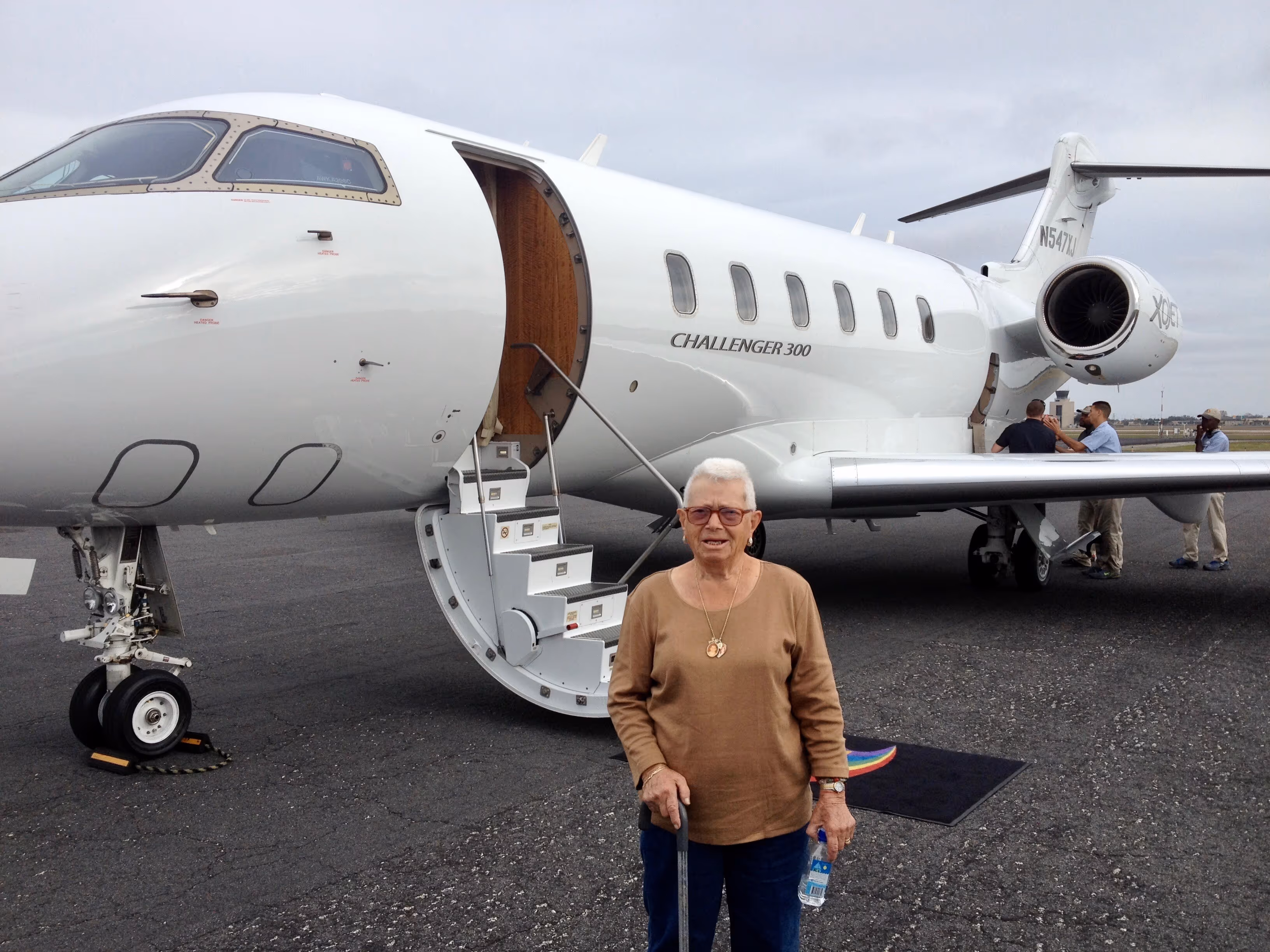 a woman standing in front of a plane