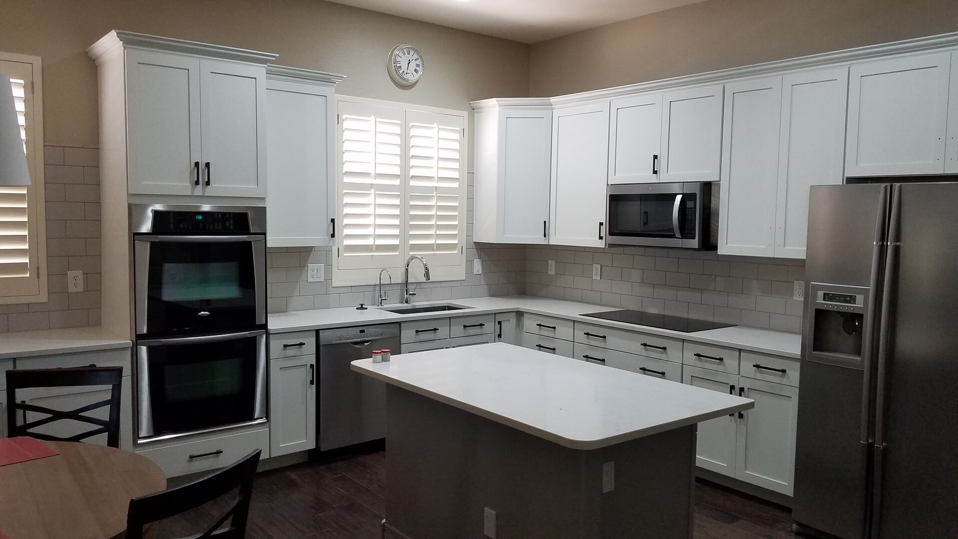 Cabinet refinishing in white, with new shaker style doors
