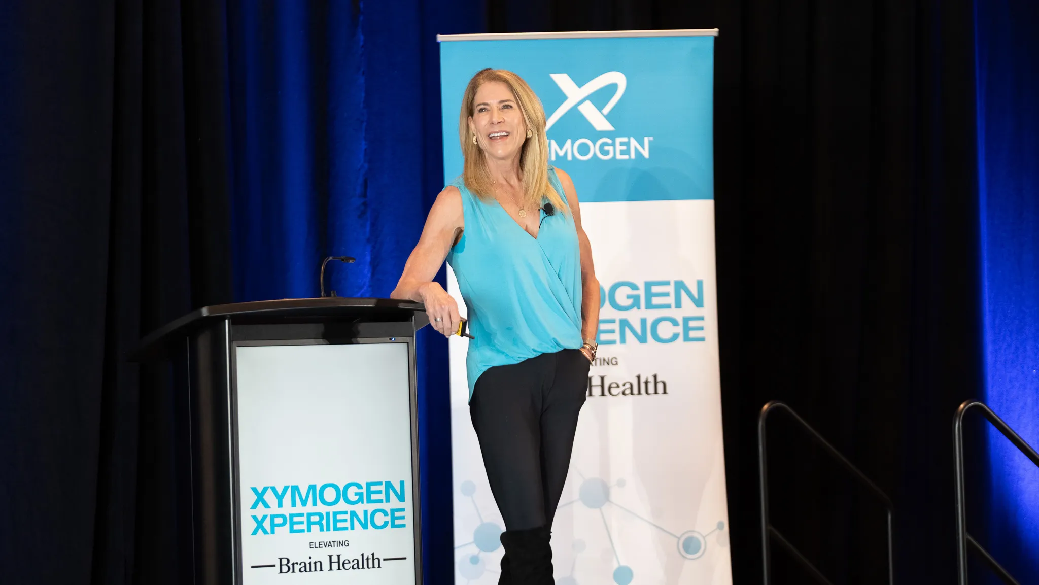 Xymogen Experience conference speaker on stage at corporate event