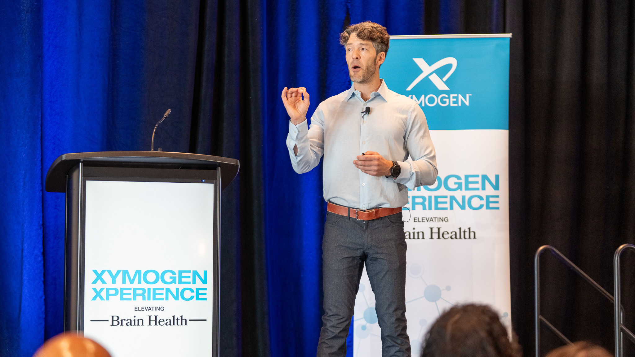 Speaker on stage at the Xymogen Xperience filmed by Mile 1 Media