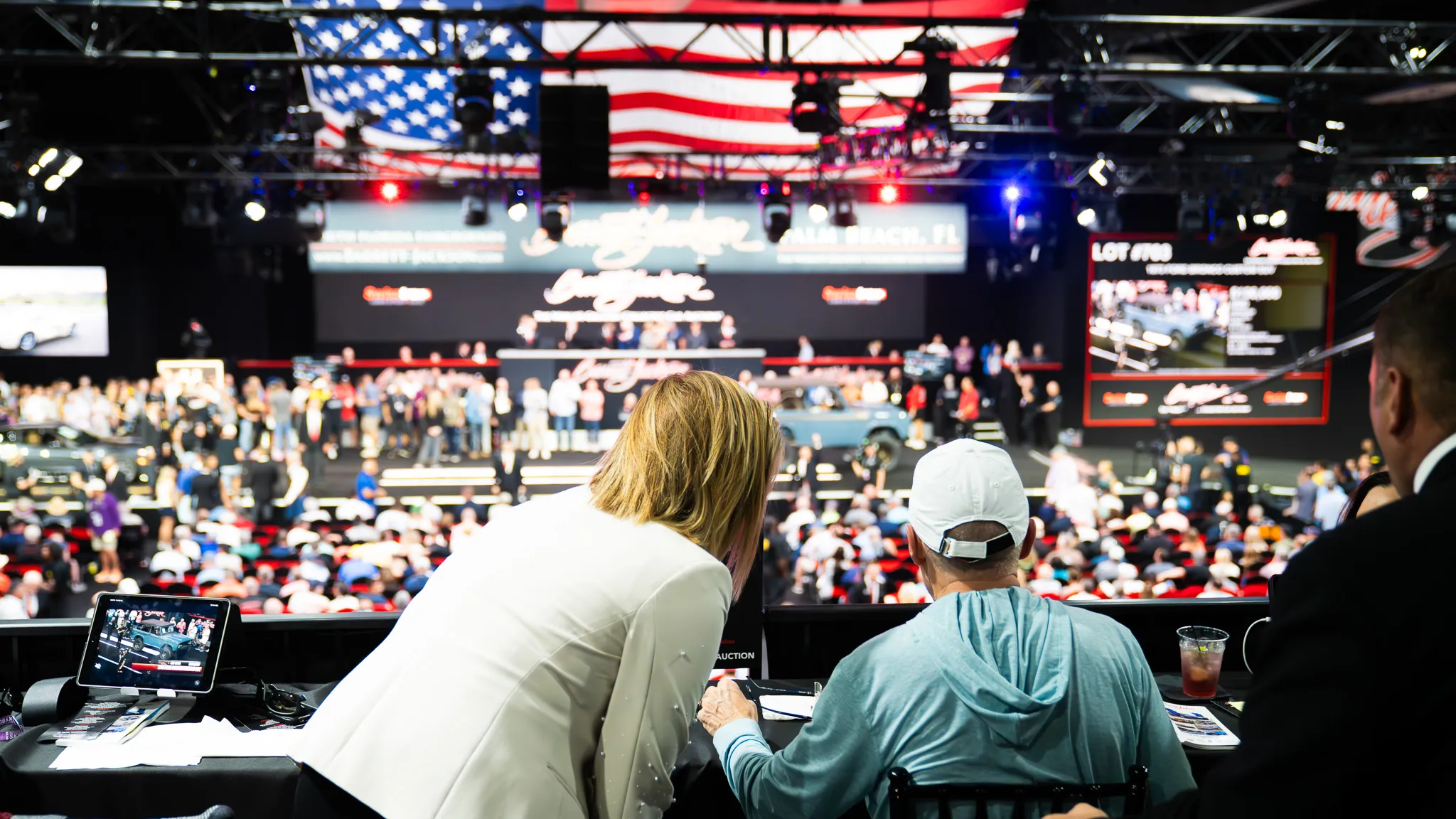 Live charity auction event with stage lighting captured by Mile 1 Media
