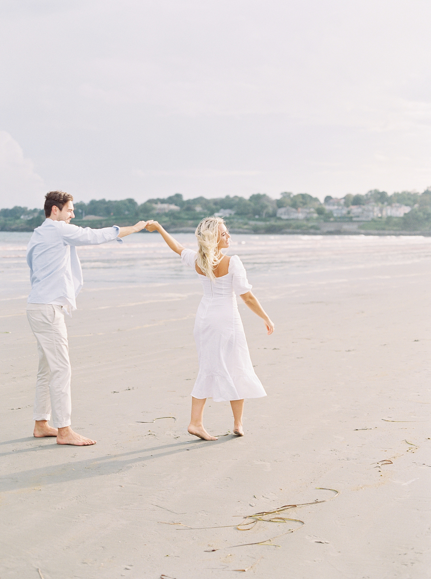 Couple walking on beach during engagement photo session in Stuart FL