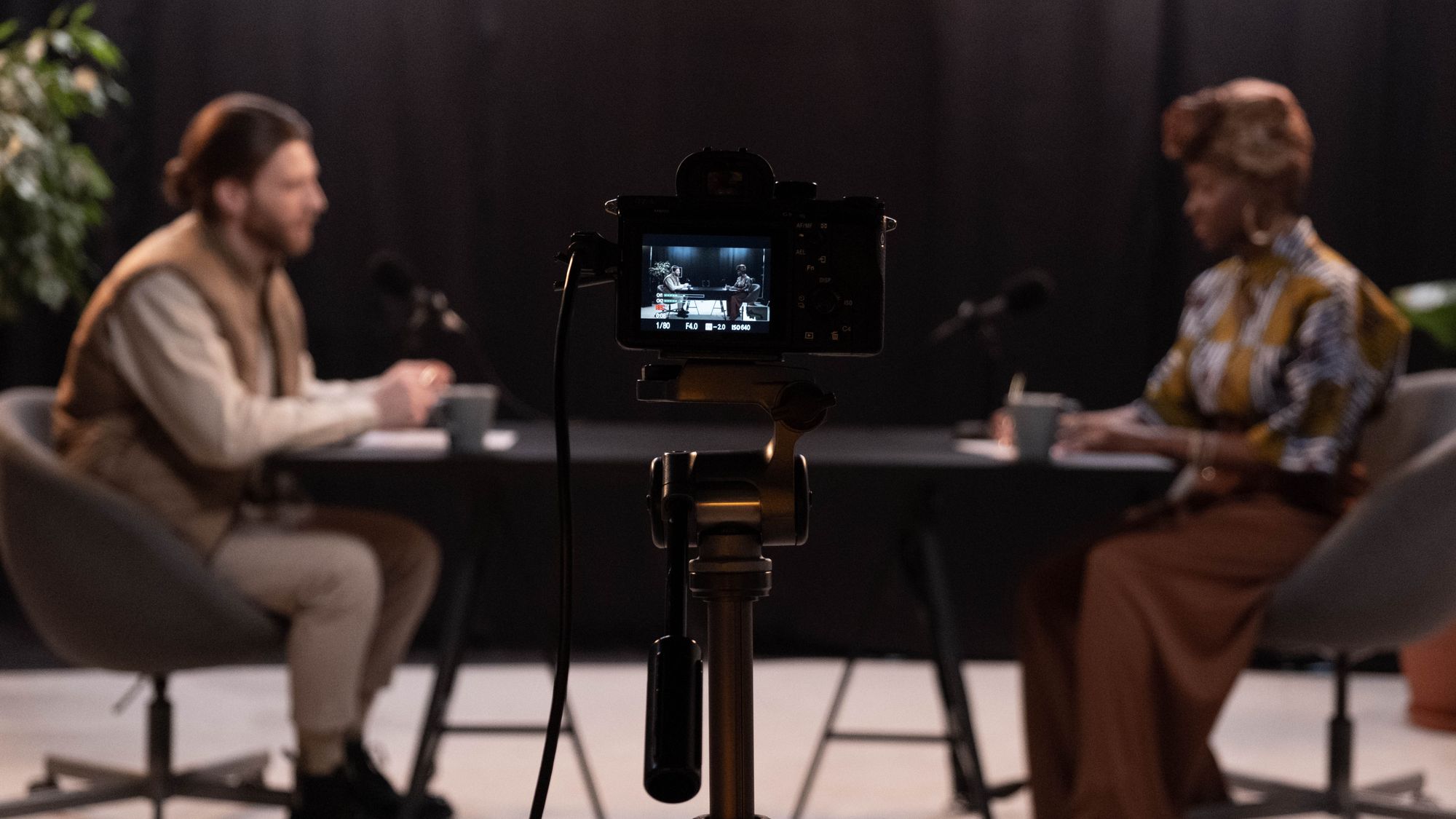 Two-camera setup recording a customer testimonial interview in an office
