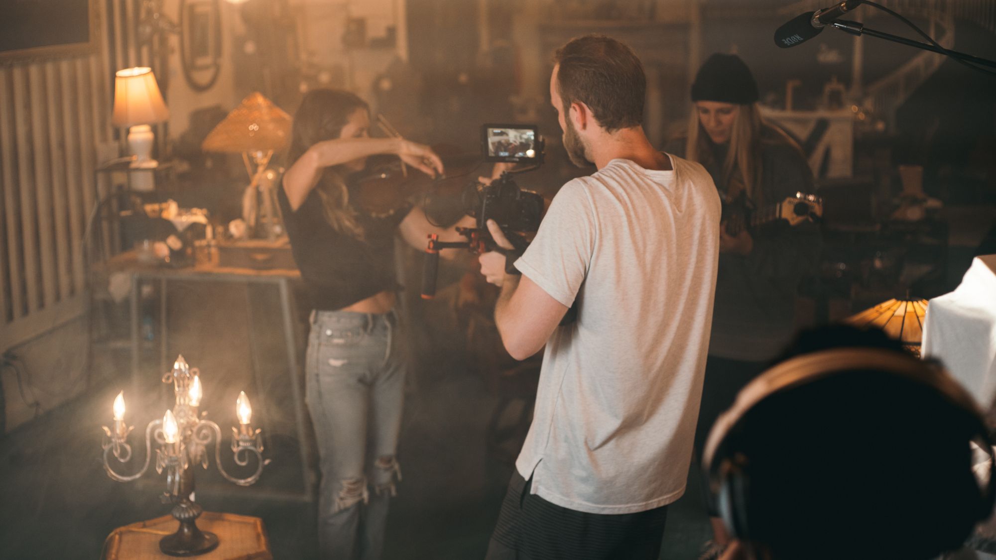 Crew members setting up lighting for an interior location video shoot