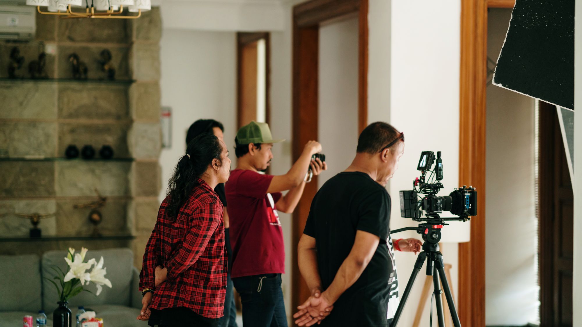 Mile 1 Media crew setting up camera and lighting for a client shoot on location in South Florida