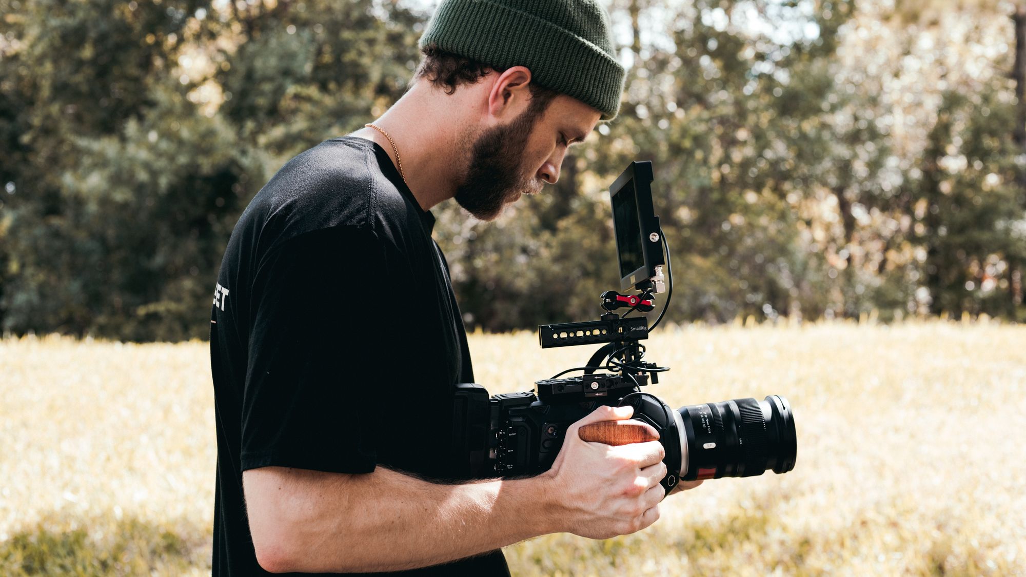 Solo camera operator using a handheld rig to capture footage for a small business video