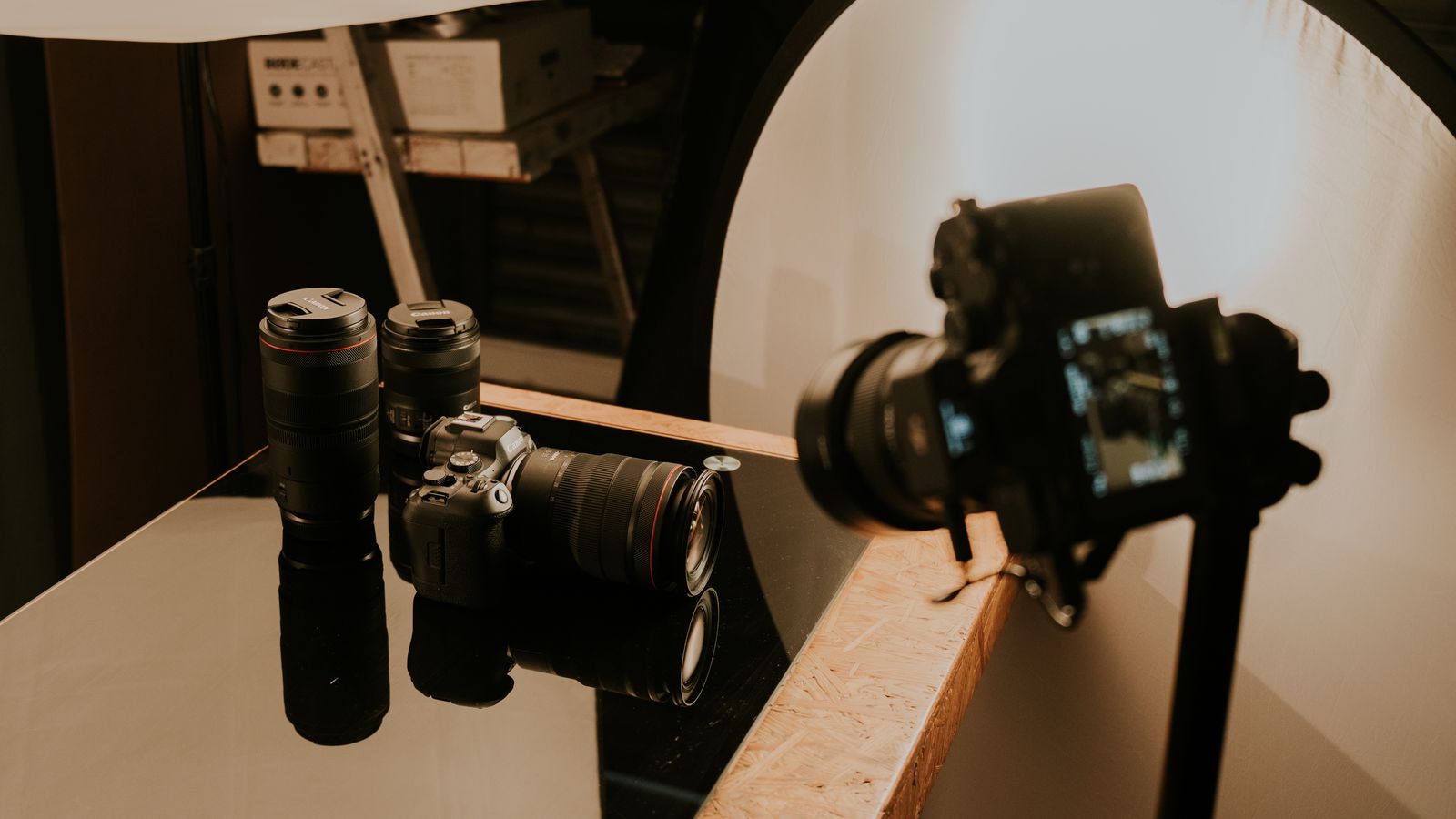 A detailed view of a professional camera setup with lenses and lighting in a studio environment.