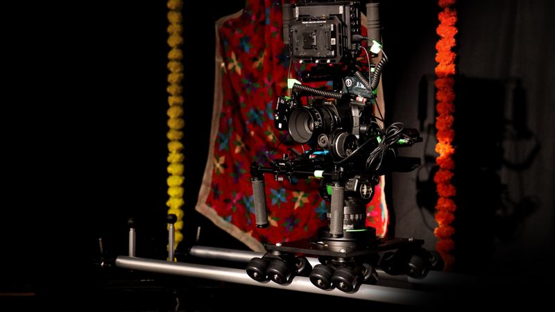 A professional camera rig setup in a vibrant studio space with colorful decorations.