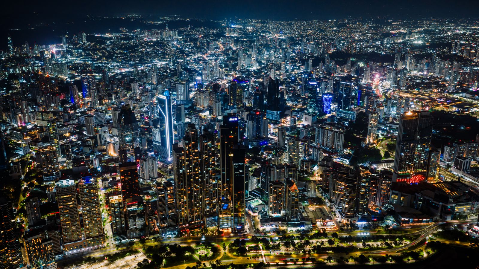 Stunning aerial shot of Panama City's vibrant skyline at night, a bustling urban landscape.