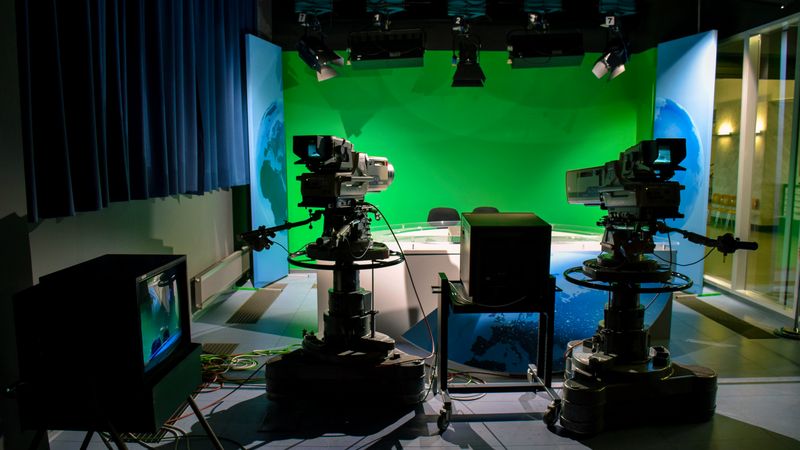 TV studio set with professional broadcast cameras and a green screen for video production