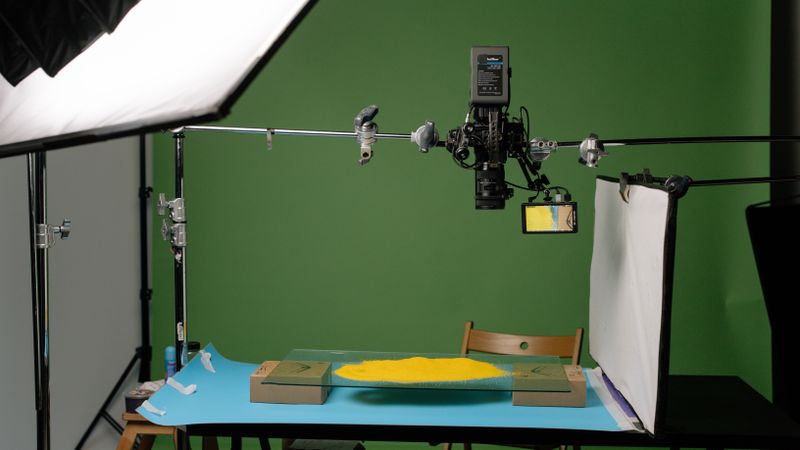 A detailed view of a professional photography studio setup, capturing products with precise lighting.