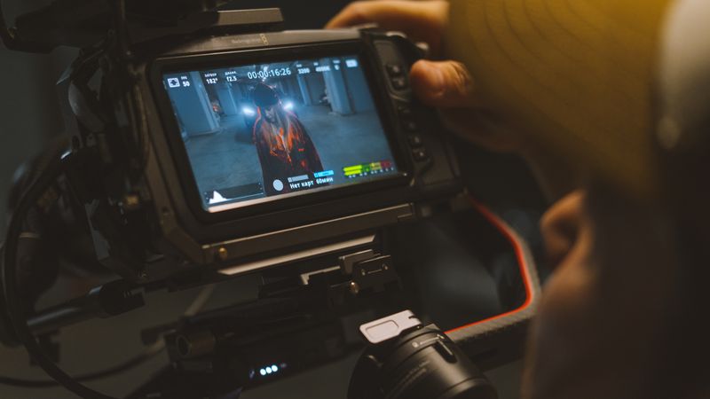 Capturing a cinematic scene with professional video camera equipment indoors.