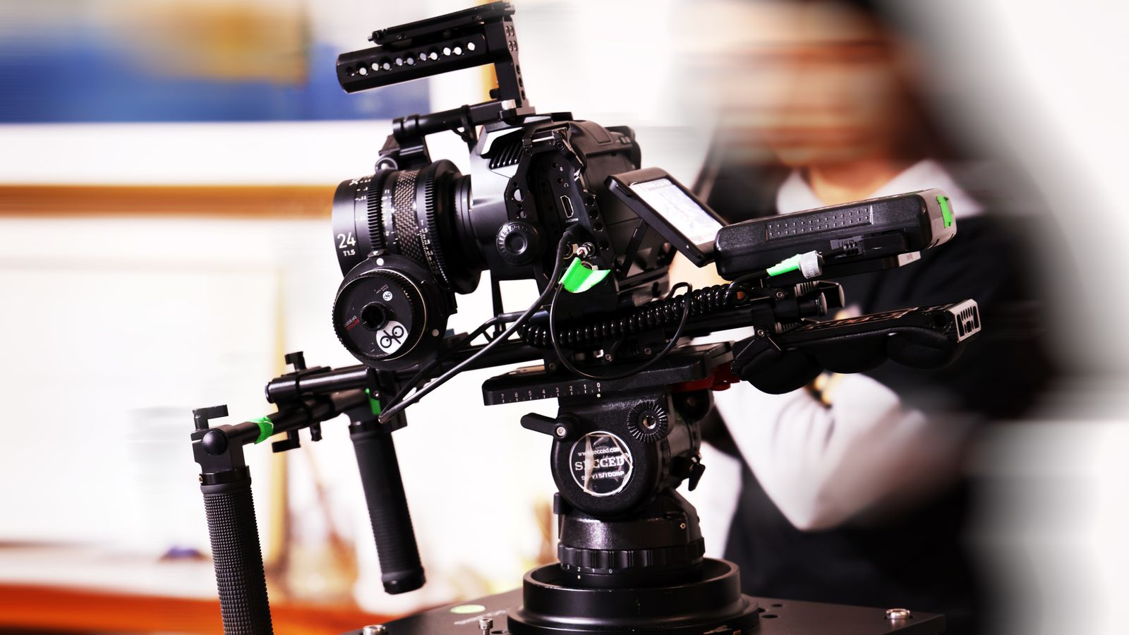High-end video camera rig in a studio environment with blurred background, capturing cinematic moments.