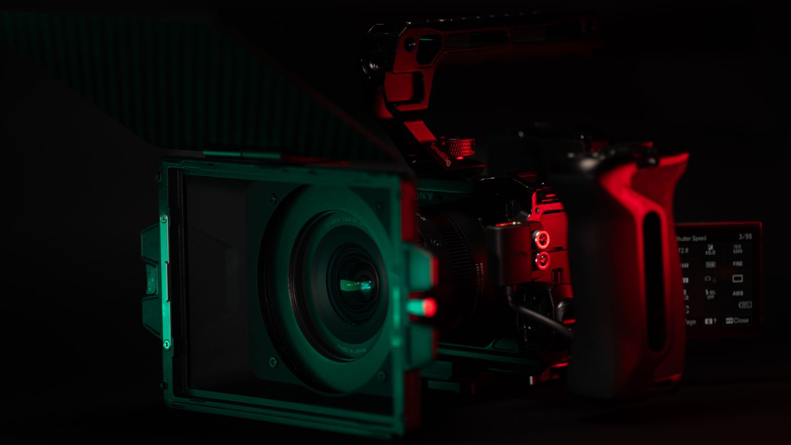 Close-up of a cinema camera rig with striking neon lighting, perfect for videography setups.