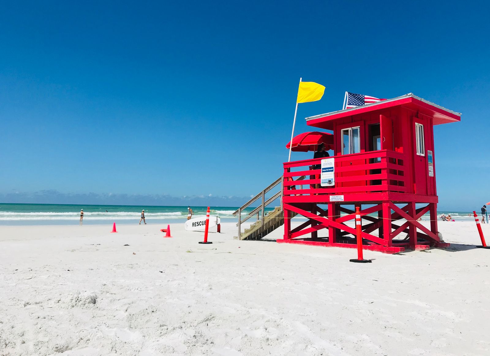 Red lifeguard tower on a white sand beach in South Florida