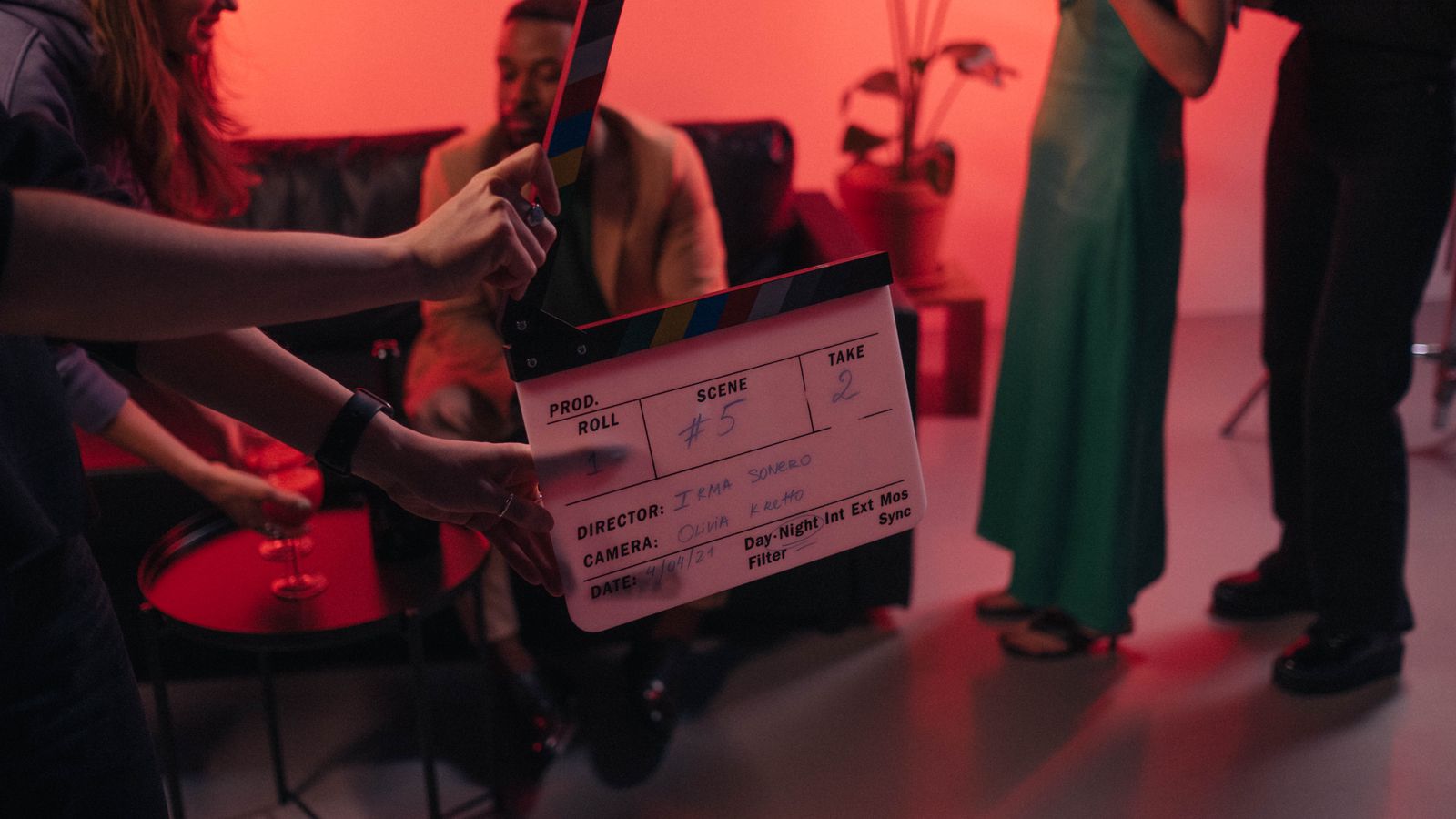 Behind the scenes of a movie set in a stylish indoor setting with clapperboard ready for action.