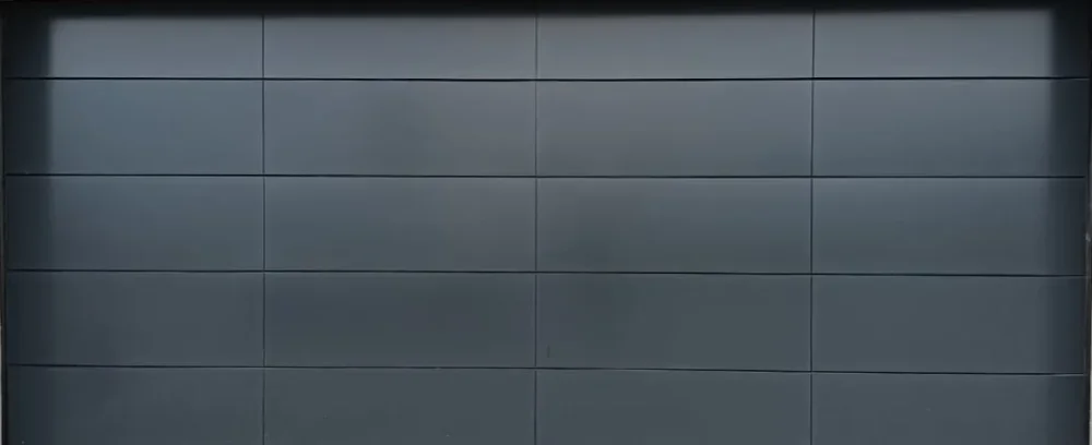 Modern dark gray garage door with horizontal panel design.