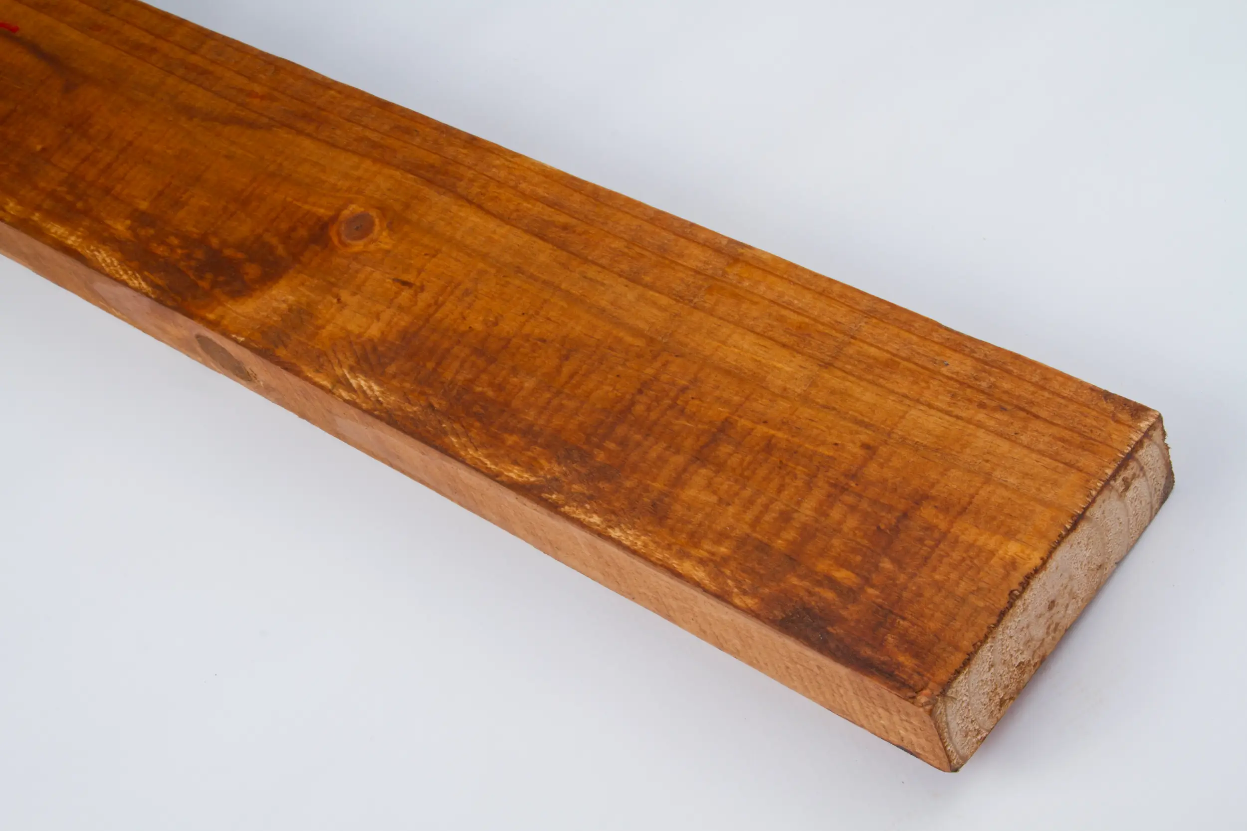 Close-up of a polished wooden plank with visible grain and knots on a white background.