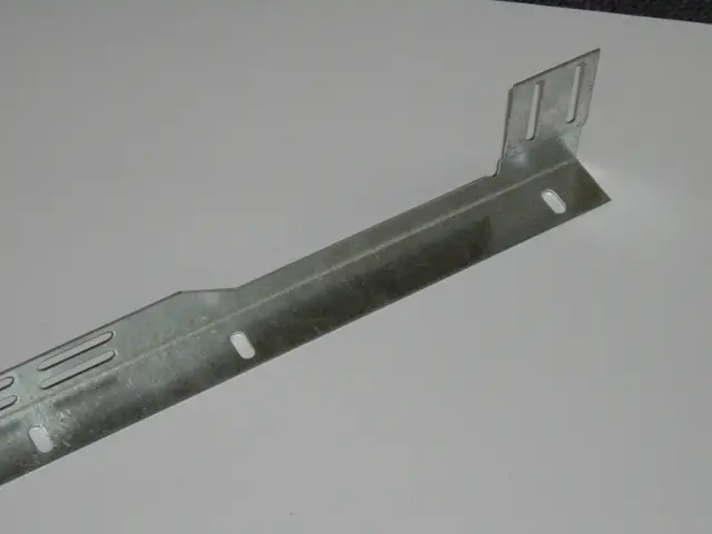 Metal bracket with multiple elongated slots and a bent end with two vertical slots on a white surface.