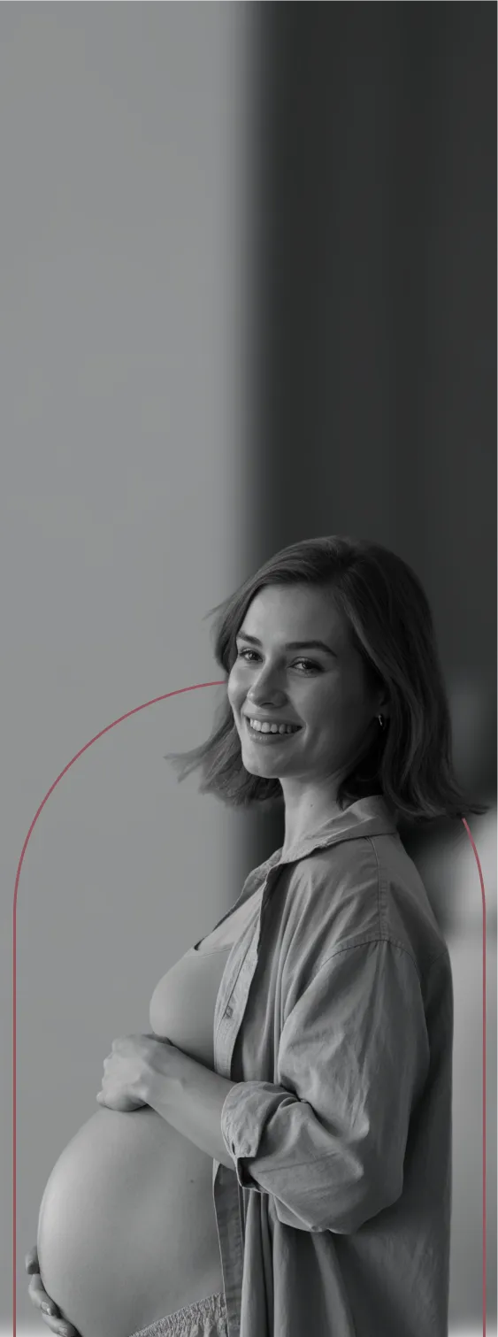 A black and white photo of a pregnant woman.